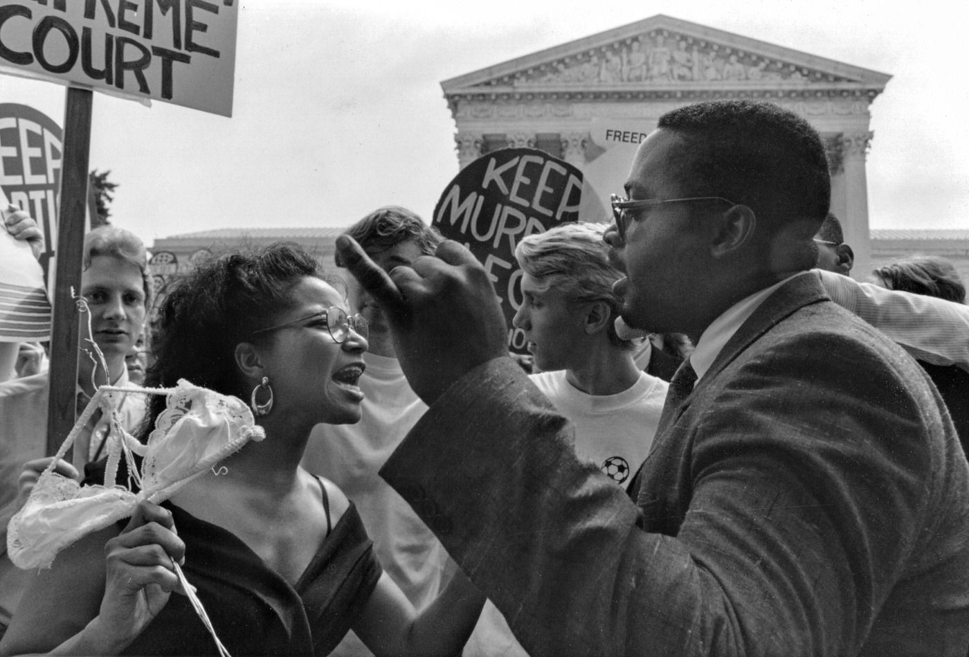 Two demonstrators shouting at each other outside the Supreme Court