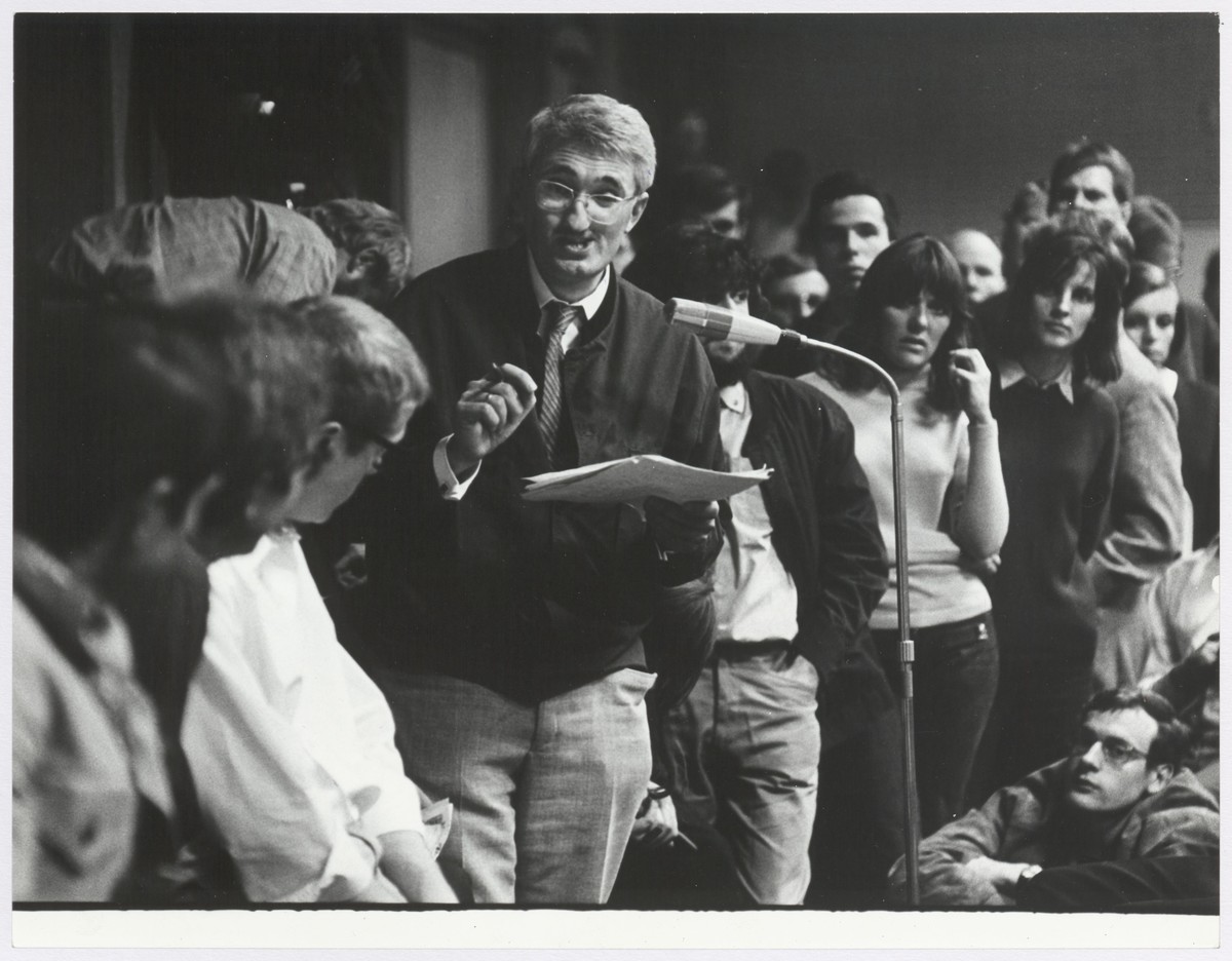 Habermas arguing with students at a microphone